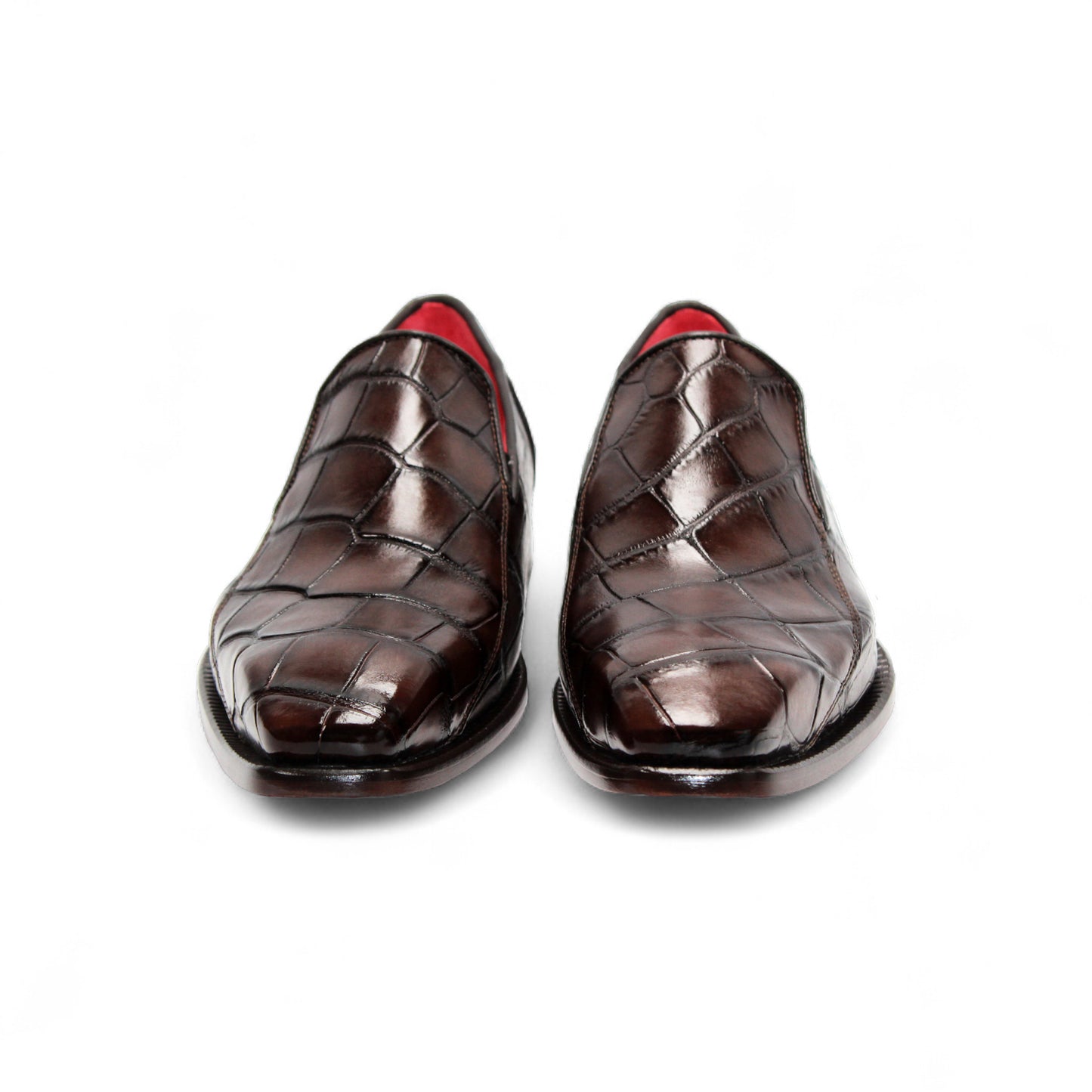 The Fennix Dustin Brown loafer by Fennix of Italy features premium brown leather, Italian craftsmanship, a textured pattern, low heel, and red interior lining, showcased in a side profile against a white background.