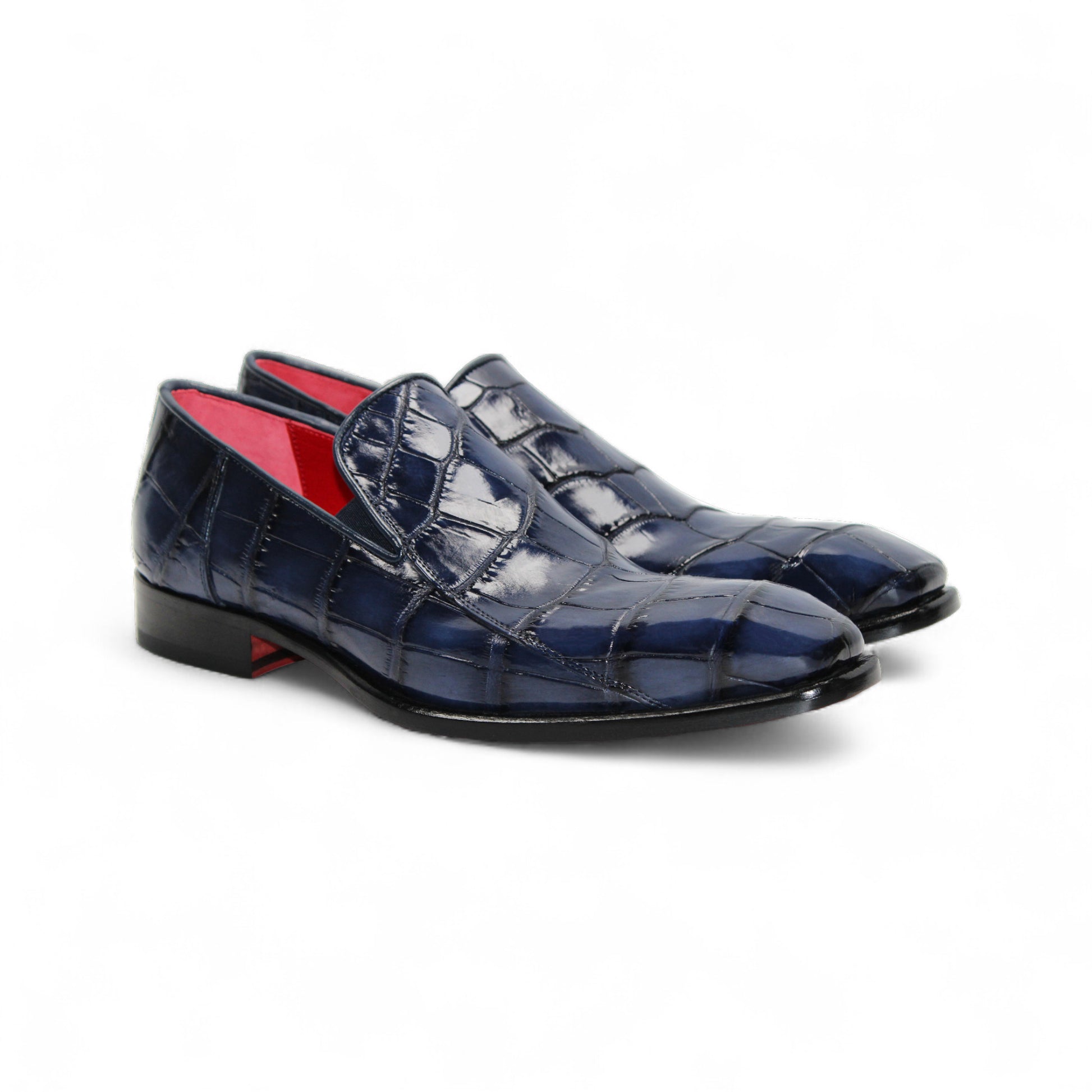 The Fennix Dustin Navy loafer by Fennix of Italy features genuine navy alligator leather with a crocodile pattern and low heel, highlighting Italian craftsmanship, shown on a white background.