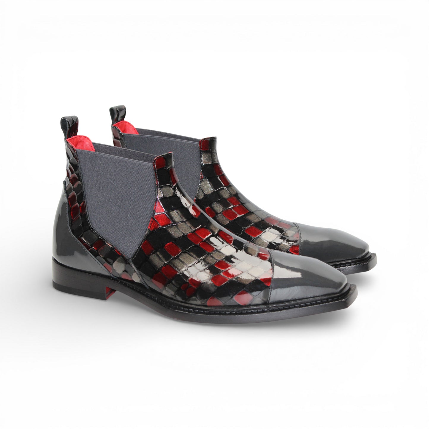 A side view of the Emilio Franco Couture EFC352 Red/Grey Chelsea boot, crafted from patent leather with a black sole, red and black checkered pattern, and an elastic gray side panel by Emilio Franco Couture.