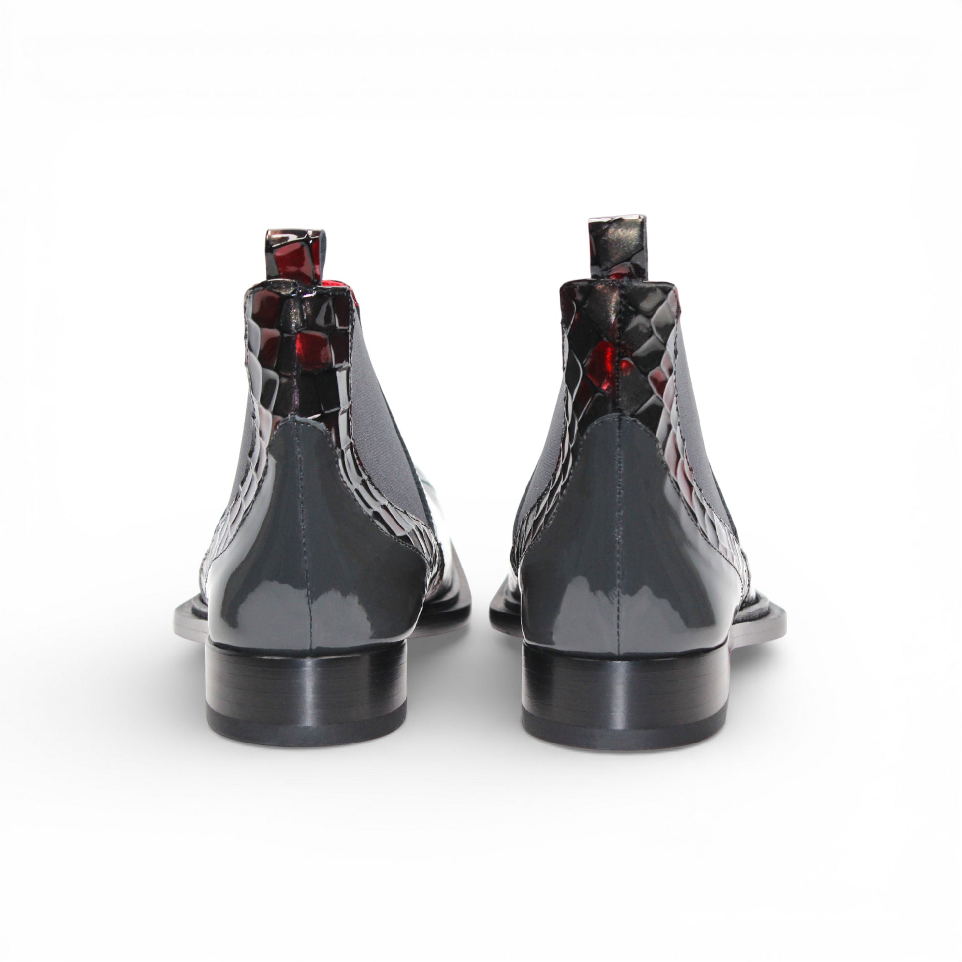 A side view of the Emilio Franco Couture EFC352 Red/Grey Chelsea boot, crafted from patent leather with a black sole, red and black checkered pattern, and an elastic gray side panel by Emilio Franco Couture.