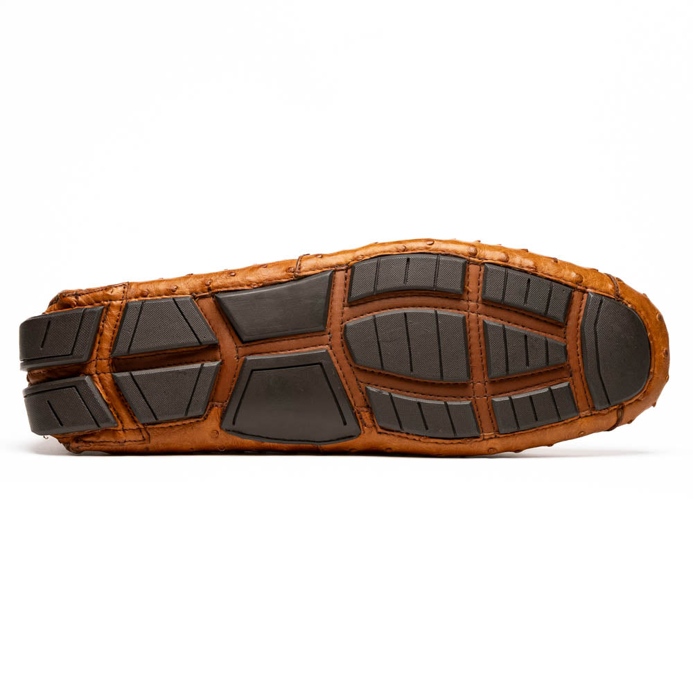 The Bolonia Brandy by Marco Di Milano—brown ostrich leather loafers with hand-painted finishes and metal buckles, one upright and one on its side revealing the sole—exude luxury, crafted from genuine exotic leather.