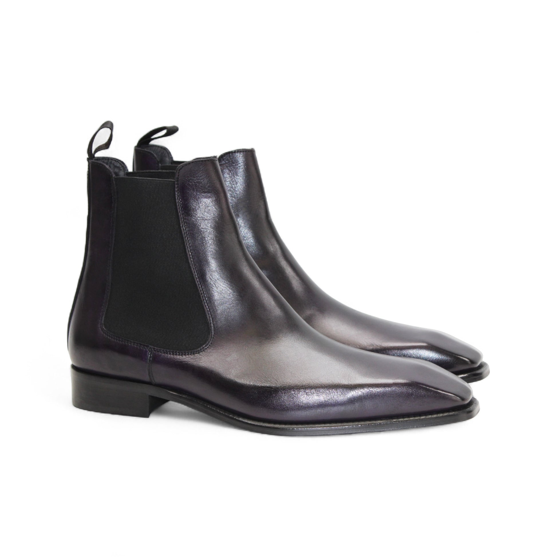 The Duca Empoli Purple by Duca Di Matiste is a dark purple leather Chelsea boot with black elastic side panels, a pull tab, low heel, and pointed toe, shown on a white background.