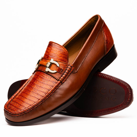 The Enzo Cognac by Marco Di Milano: men's brown leather loafers with a textured pattern, hand-painted finish, gold buckle, and black soles, shown on a white background.