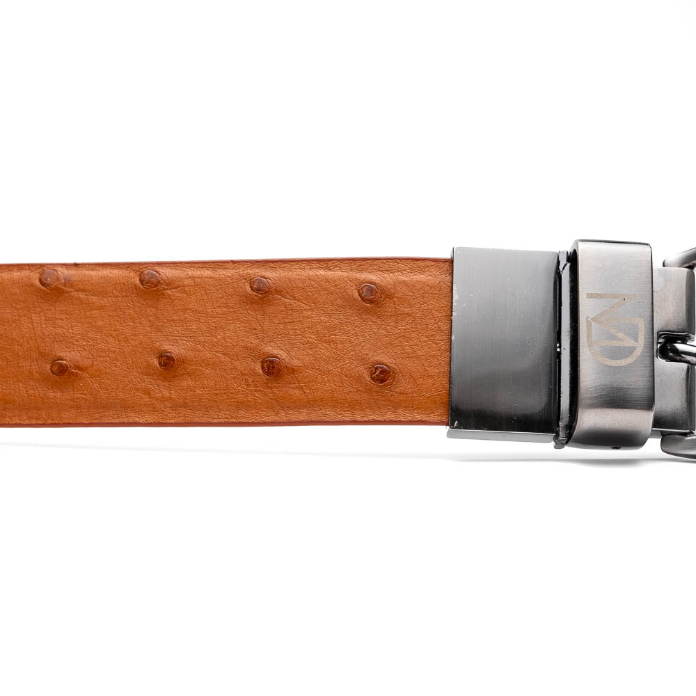 The Domenico Belt Brandy by Marco Di Milano, featuring rich brown ostrich leather and a silver branded buckle, is coiled on a white background—an elegant accessory to complement luxury footwear.