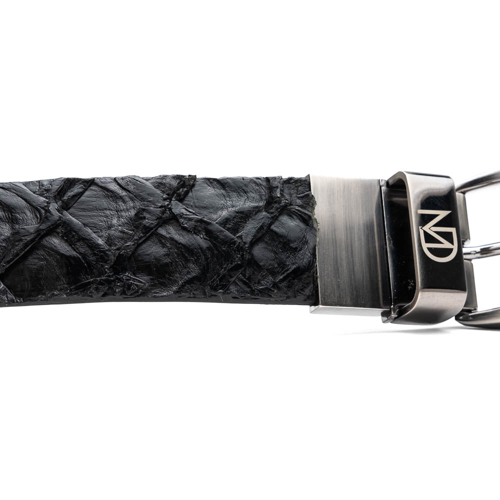 The Olivieri Belt Black by Marco Di Milano is a textured genuine pirarucu belt with a silver buckle, featuring the brand's logo—a refined accessory that pairs seamlessly with Marco Di Milano luxury footwear.
