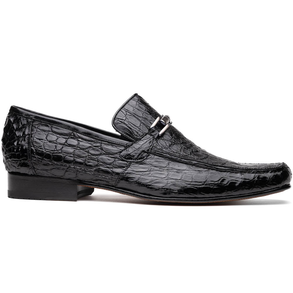 A pair of Fabro-Tin Black textured men's shoes by Marco Di Milano, featuring metal accents—one upright and one on its side showing the branded tan sole.