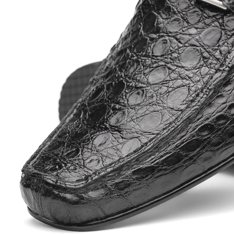 A pair of Marco Di Milano Fabro-Tin Gray loafers—one upright, one on its side revealing the brown sole—exemplify luxury men's footwear.