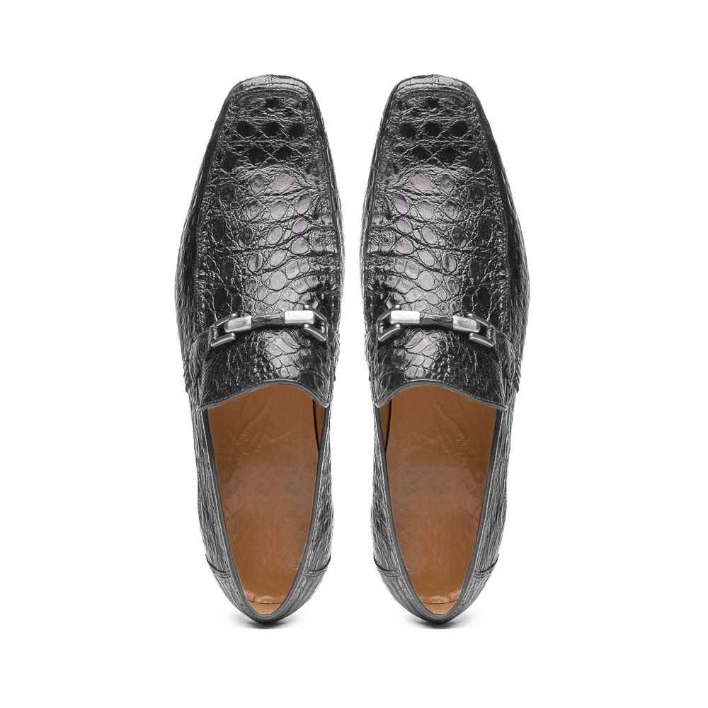 A pair of Marco Di Milano Fabro-Tin Gray loafers—one upright, one on its side revealing the brown sole—exemplify luxury men's footwear.
