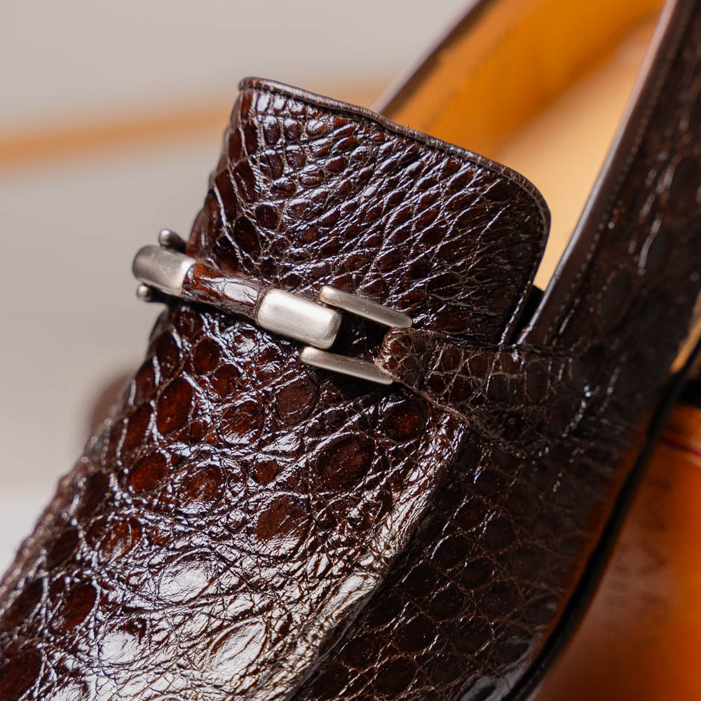 The Fabro-Tin Brown loafers by Marco Di Milano feature dark brown genuine alligator leather, metal bit detail, tan leather soles, and square toes—a true statement in luxury men's footwear.