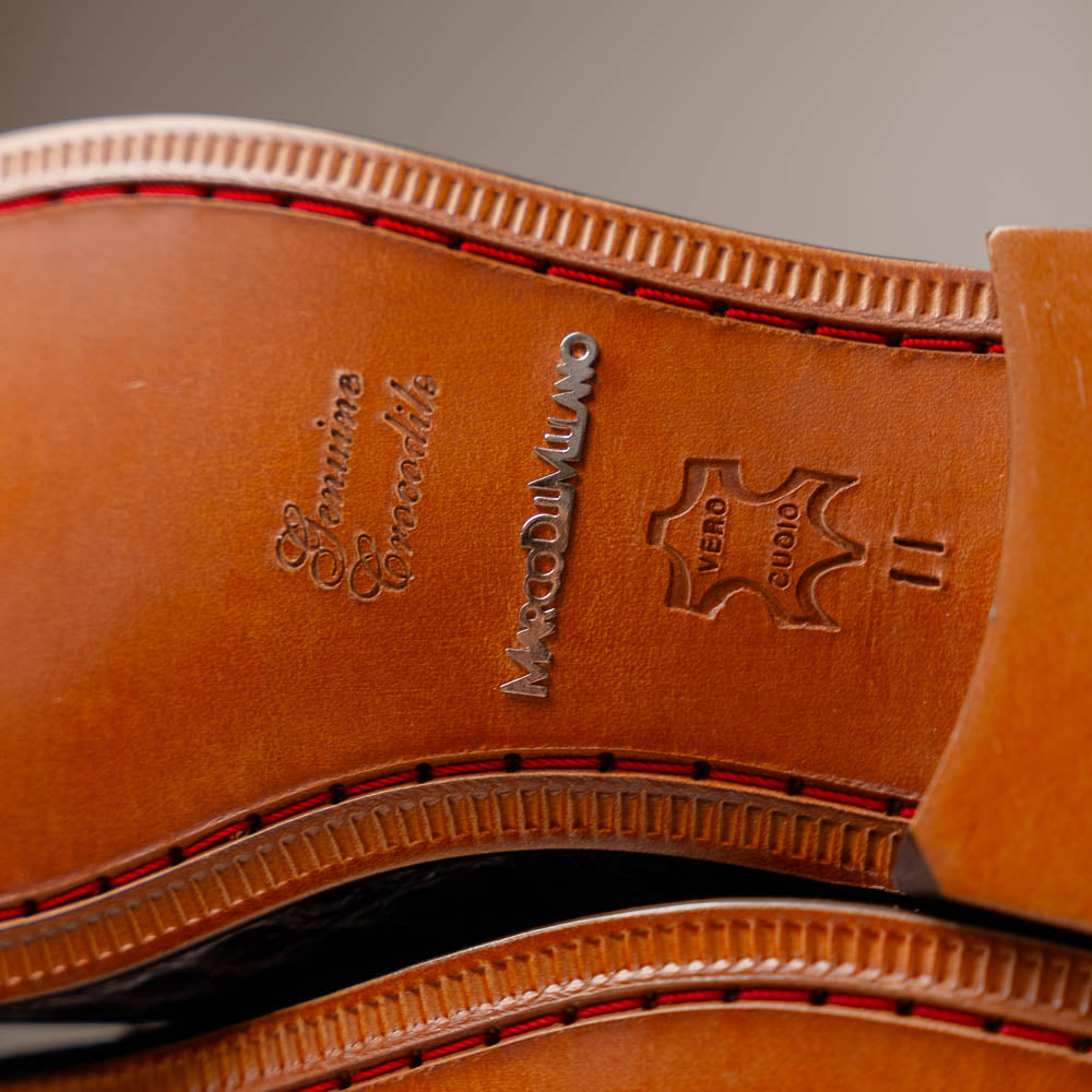 The Fabro-Tin Brown loafers by Marco Di Milano feature dark brown genuine alligator leather, metal bit detail, tan leather soles, and square toes—a true statement in luxury men's footwear.