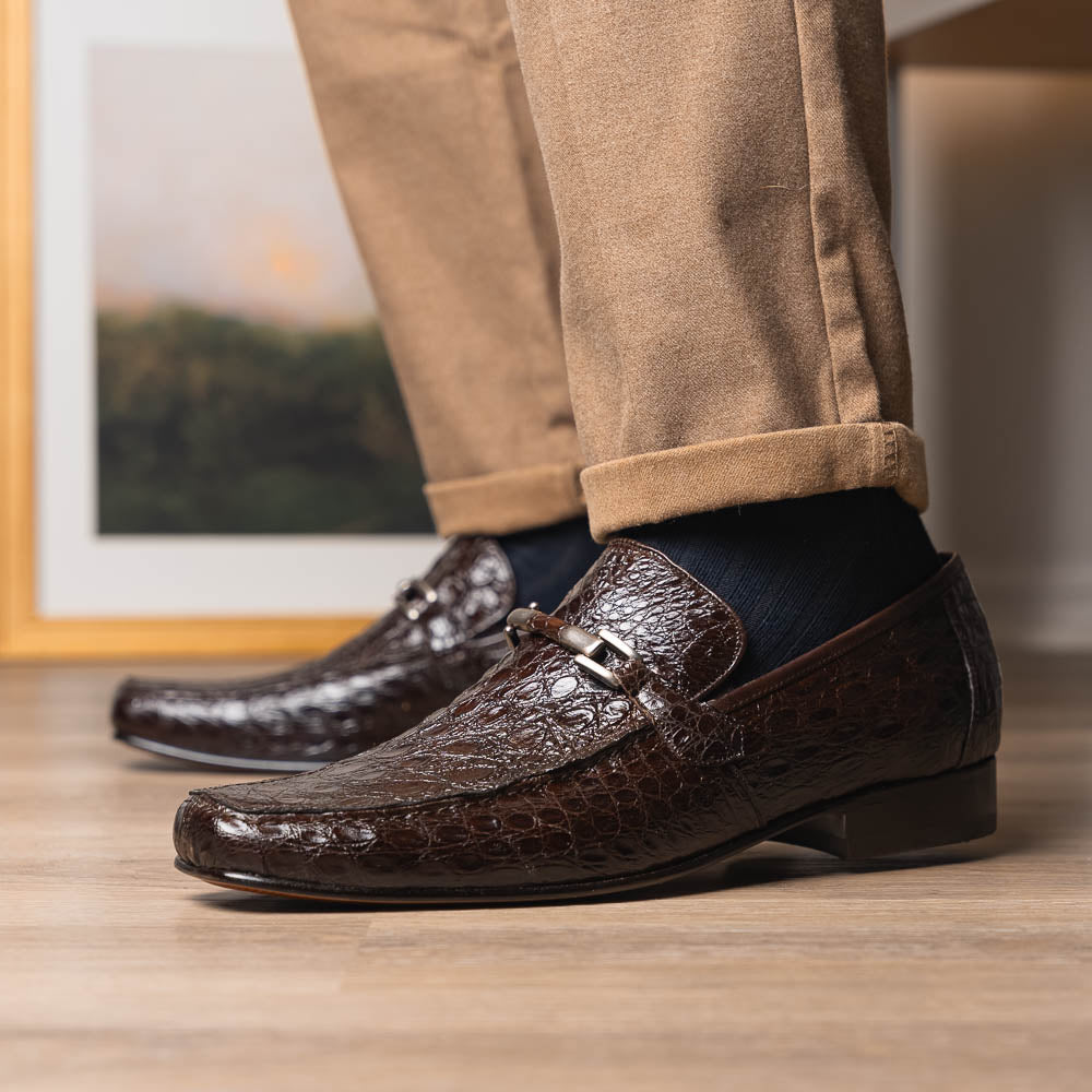 The Fabro-Tin Brown loafers by Marco Di Milano feature dark brown genuine alligator leather, metal bit detail, tan leather soles, and square toes—a true statement in luxury men's footwear.