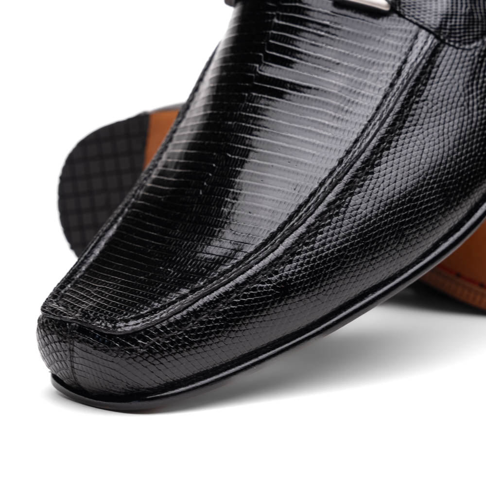A pair of Marco Di Milano Fabro-Liz Black genuine lizard loafers, featuring textured leather, metal accents, and brown soles—one upright, the other on its side showing the luxury men's shoes branding on the sole.