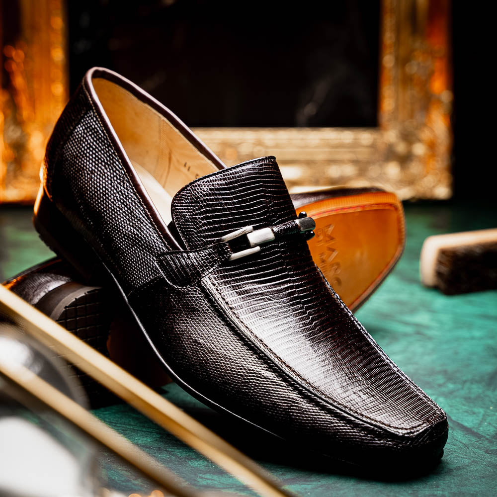 The Marco Di Milano Fabro-Liz Brown loafers feature a textured lizard finish, silver buckle detail, and tan leather soles—ideal for luxury footwear enthusiasts.