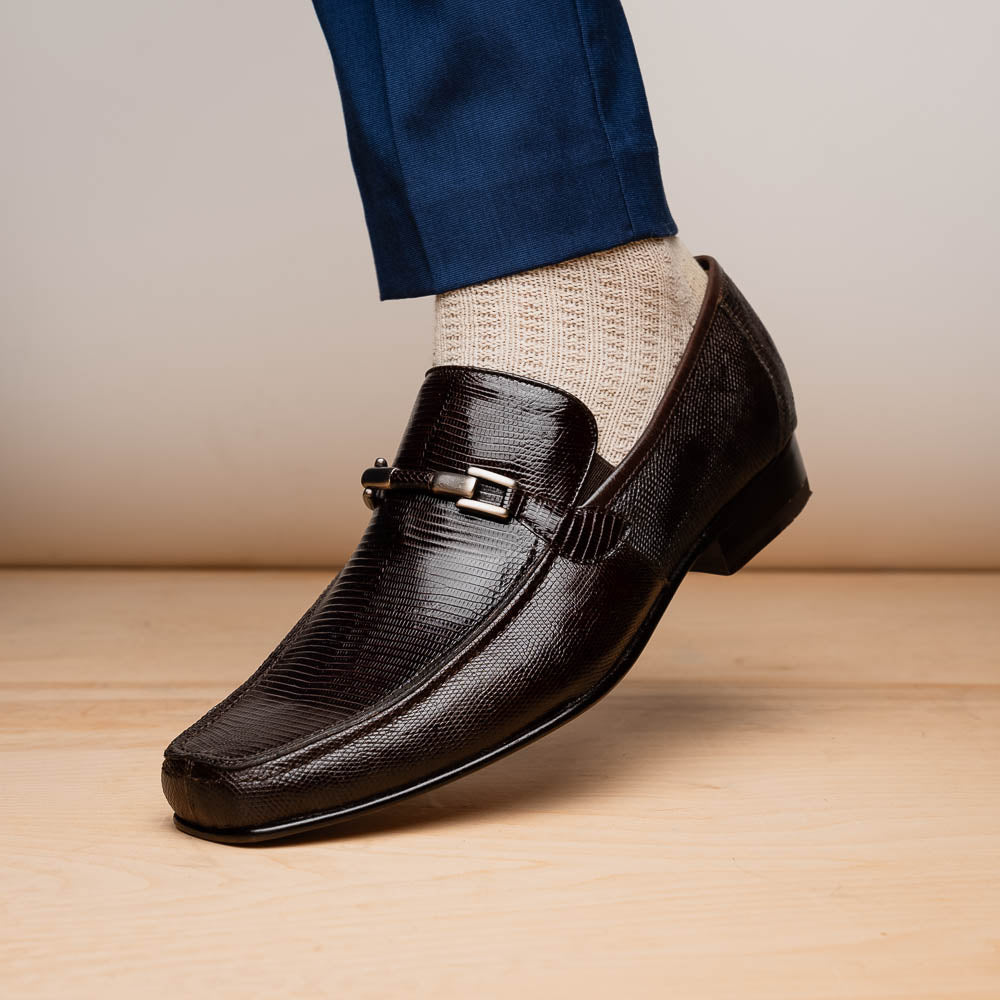 The Marco Di Milano Fabro-Liz Brown loafers feature a textured lizard finish, silver buckle detail, and tan leather soles—ideal for luxury footwear enthusiasts.