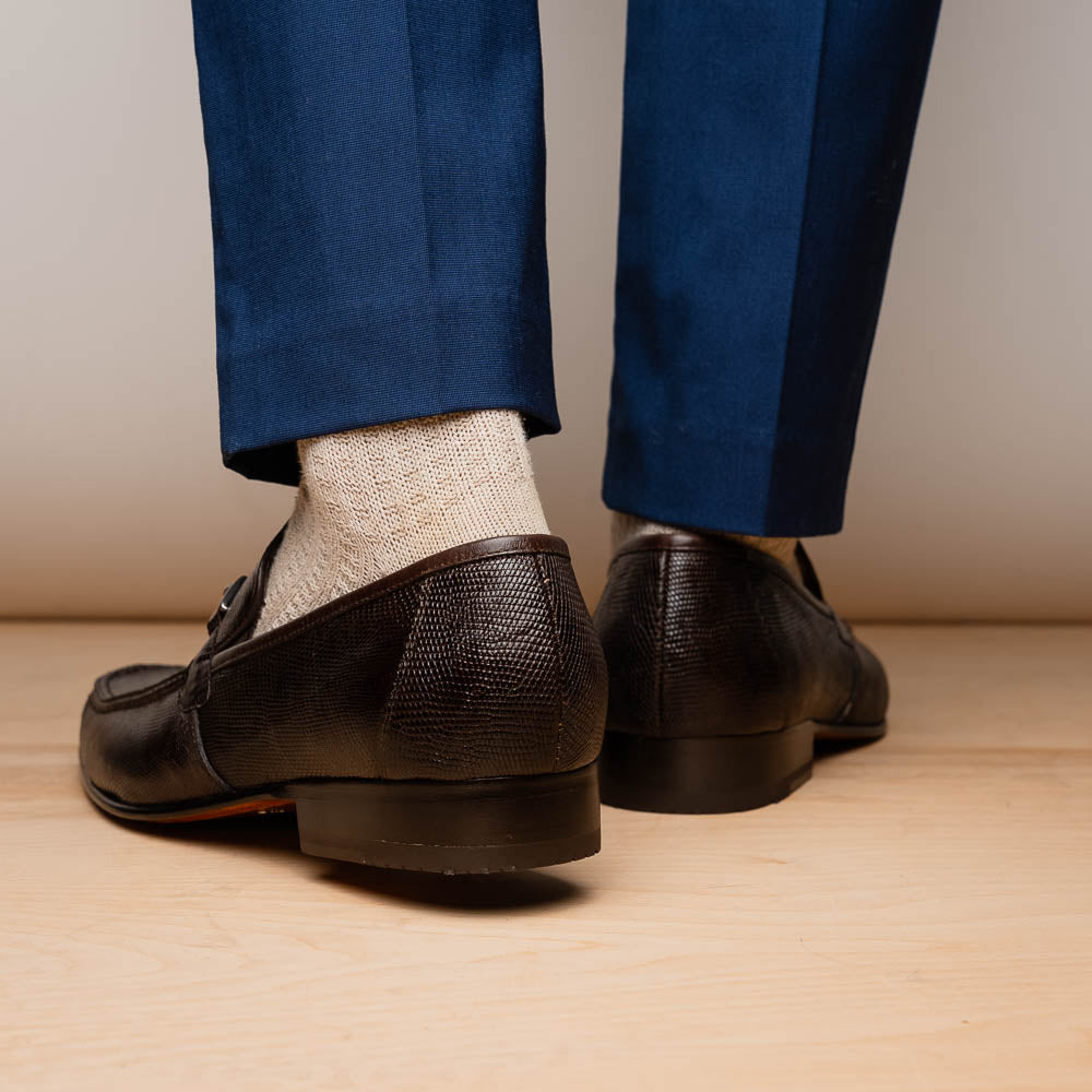 The Marco Di Milano Fabro-Liz Brown loafers feature a textured lizard finish, silver buckle detail, and tan leather soles—ideal for luxury footwear enthusiasts.