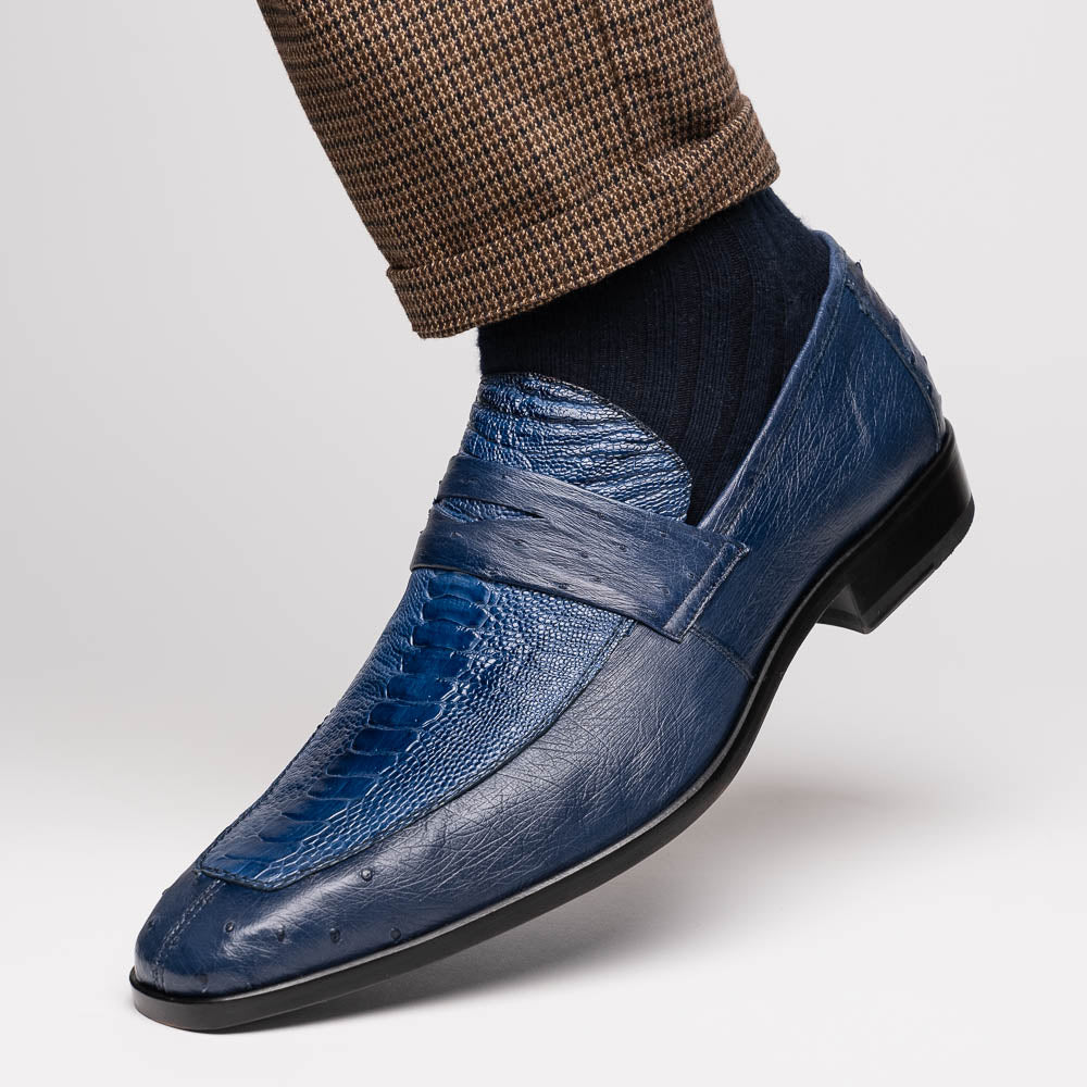 The Marco Di Milano Fangio Denim Blue features genuine ostrich loafers with textured blue uppers and red lining—one upright, one on its side displaying the sole—a standout addition to any luxury men’s footwear collection.