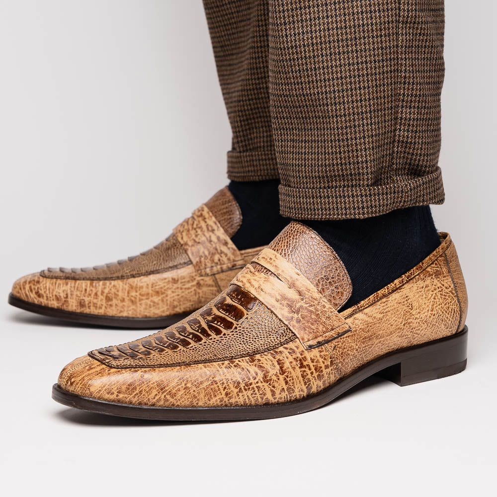 The Fangio Orix by Marco Di Milano: tan textured genuine ostrich loafers with dark brown soles, one upright and one on its side to display the sole—luxury men's shoes with hand-painted finishes.