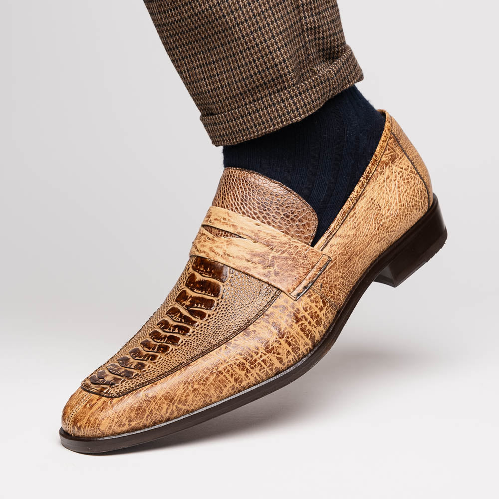 The Fangio Orix by Marco Di Milano: tan textured genuine ostrich loafers with dark brown soles, one upright and one on its side to display the sole—luxury men's shoes with hand-painted finishes.