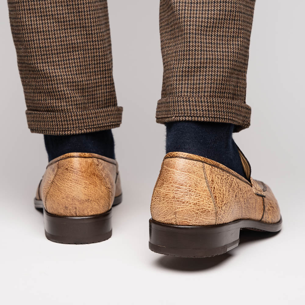 The Fangio Orix by Marco Di Milano: tan textured genuine ostrich loafers with dark brown soles, one upright and one on its side to display the sole—luxury men's shoes with hand-painted finishes.