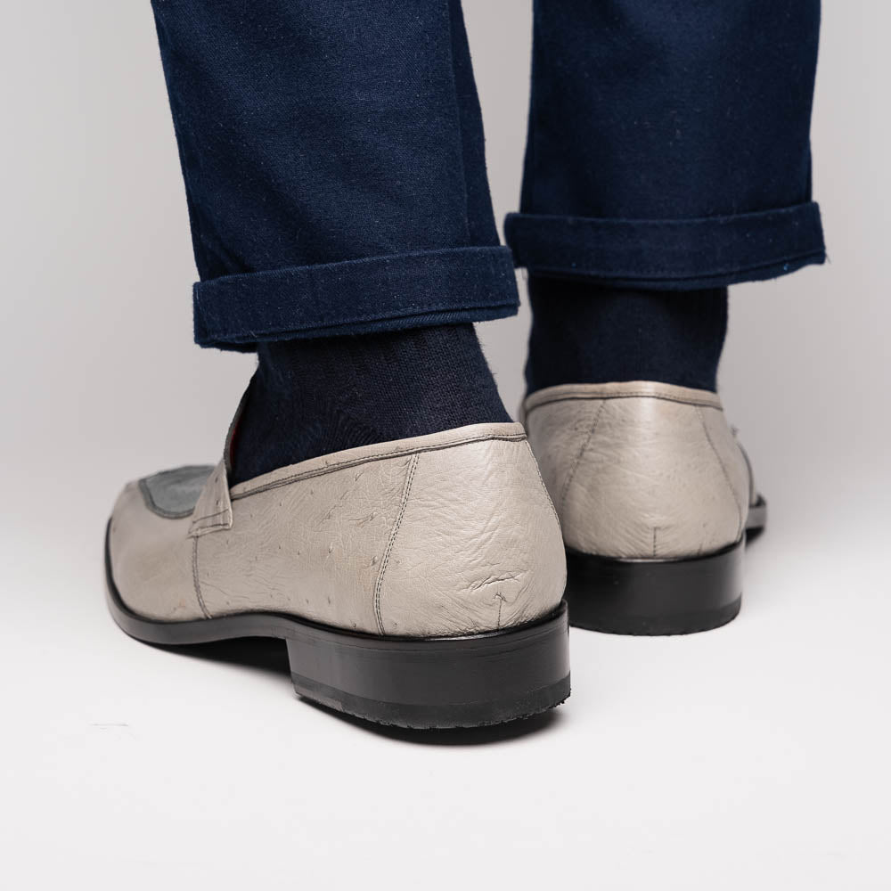 A pair of Marco Di Milano Fangio Gray formal slip-on dress shoes with textured leather and a hand-painted finish, one upright and the other on its side displaying the sole.