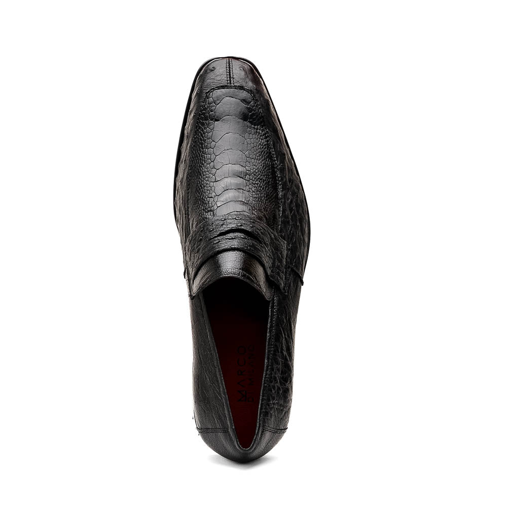 The Fangio Black by Marco Di Milano: a pair of black textured leather loafers, one upright and one sole-up, displaying the brand on the tan sole—luxury men's footwear to elevate any look.