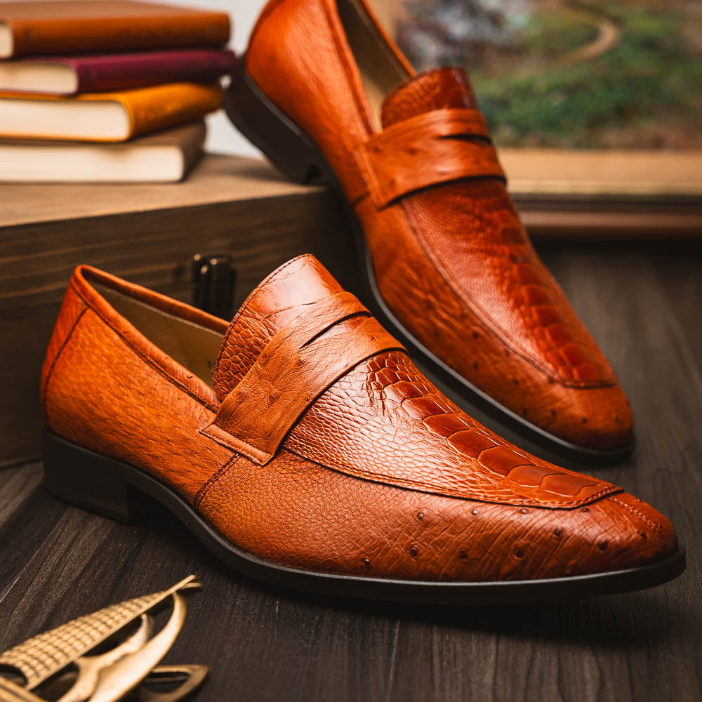 A pair of Marco Di Milano Fangio Cognac men's shoes in brown leather with textured detailing; one genuine ostrich loafer stands upright, while the other lies on its side showing the sole embossed with the brand name.