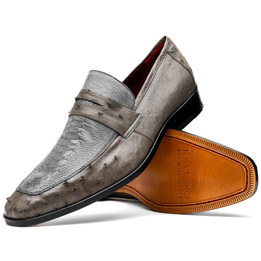 The Fangio Serpentine Gray by Marco Di Milano features gray textured leather in classic penny loafer style, with detailed stitching and tan leather soles—one shoe upright, one on its side—to showcase refined craftsmanship.