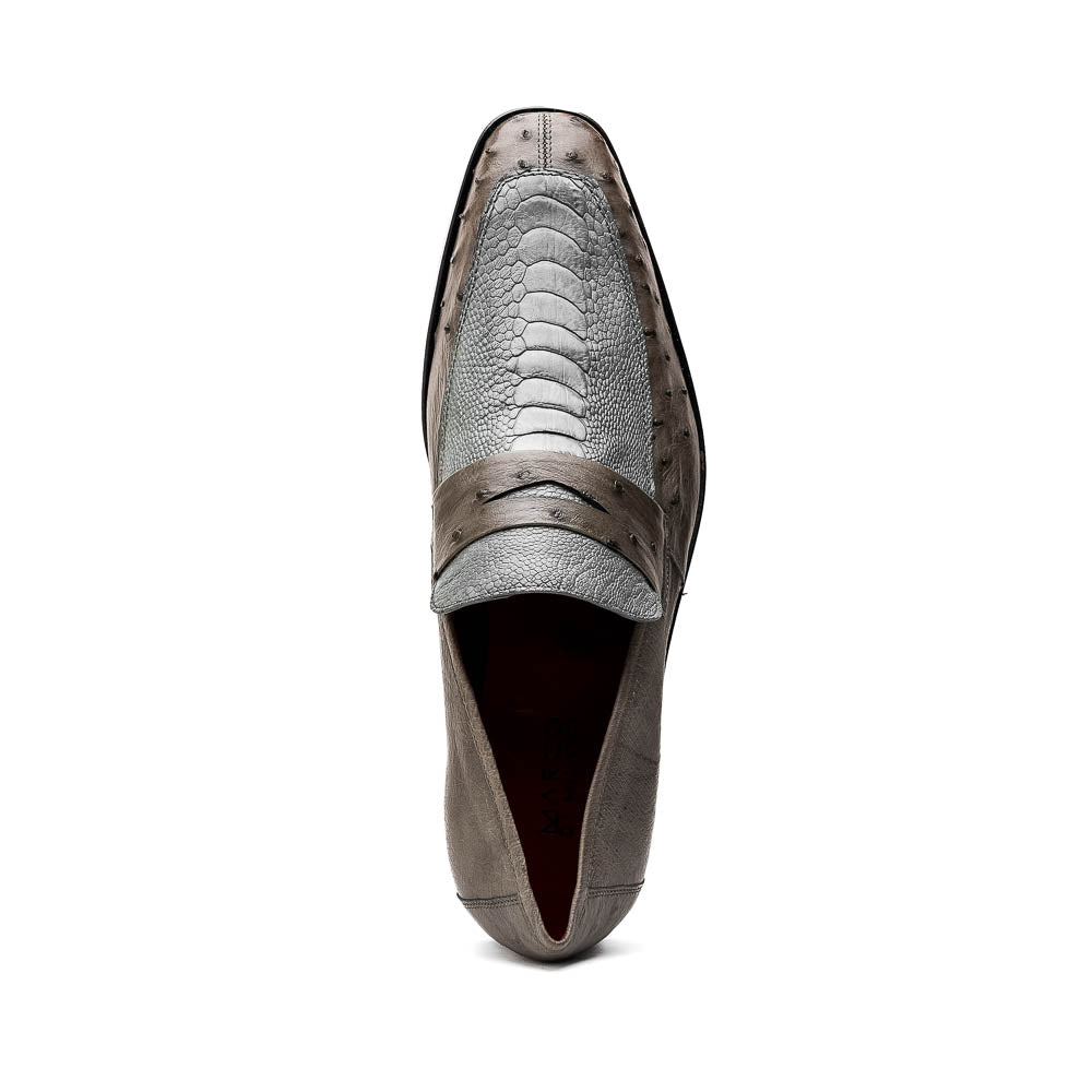 The Fangio Serpentine Gray by Marco Di Milano features gray textured leather in classic penny loafer style, with detailed stitching and tan leather soles—one shoe upright, one on its side—to showcase refined craftsmanship.