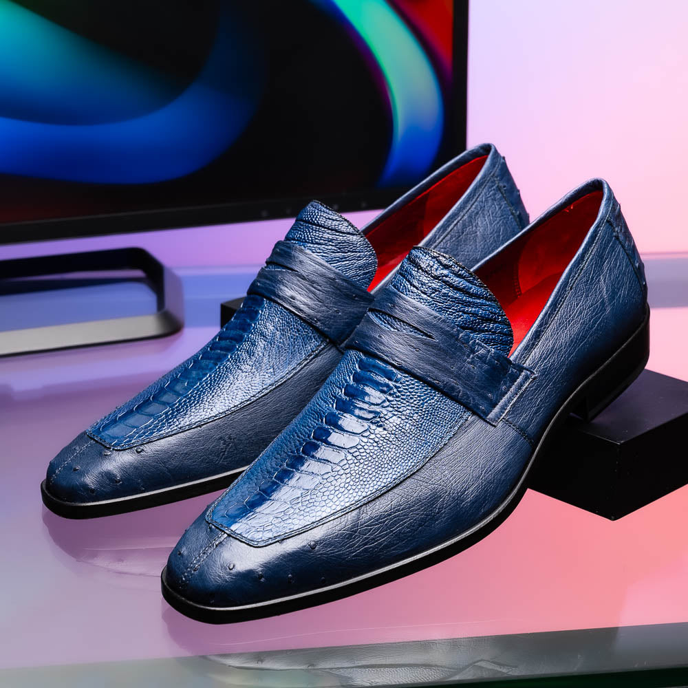 The Marco Di Milano Fangio Denim Blue features genuine ostrich loafers with textured blue uppers and red lining—one upright, one on its side displaying the sole—a standout addition to any luxury men’s footwear collection.