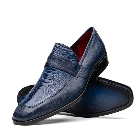 The Marco Di Milano Fangio Denim Blue features genuine ostrich loafers with textured blue uppers and red lining—one upright, one on its side displaying the sole—a standout addition to any luxury men’s footwear collection.