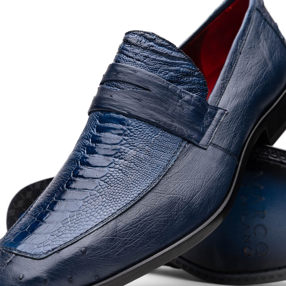 The Marco Di Milano Fangio Denim Blue features genuine ostrich loafers with textured blue uppers and red lining—one upright, one on its side displaying the sole—a standout addition to any luxury men’s footwear collection.