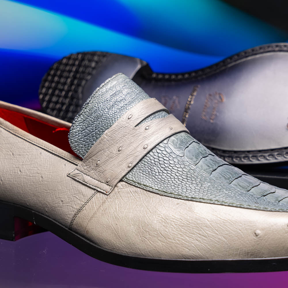 A pair of Marco Di Milano Fangio Gray formal slip-on dress shoes with textured leather and a hand-painted finish, one upright and the other on its side displaying the sole.