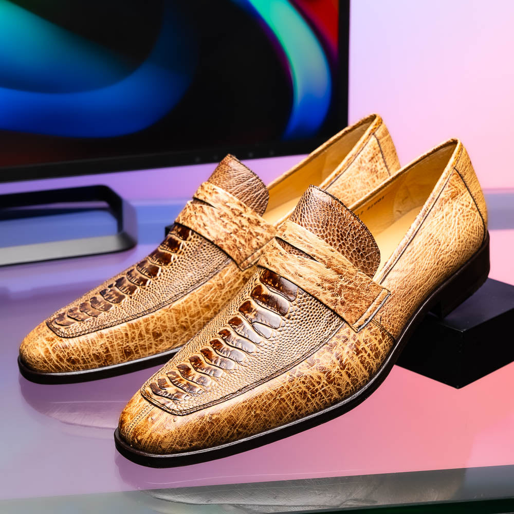 The Fangio Orix by Marco Di Milano: tan textured genuine ostrich loafers with dark brown soles, one upright and one on its side to display the sole—luxury men's shoes with hand-painted finishes.