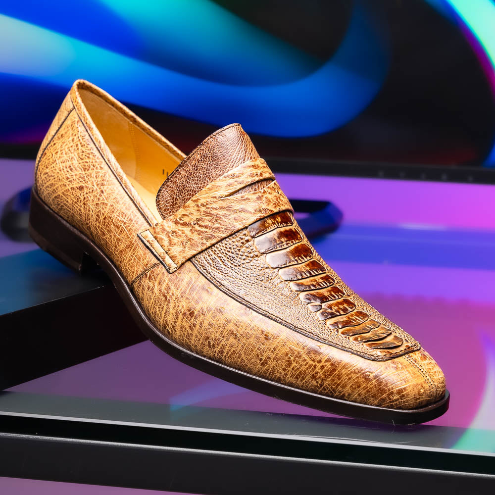 The Fangio Orix by Marco Di Milano: tan textured genuine ostrich loafers with dark brown soles, one upright and one on its side to display the sole—luxury men's shoes with hand-painted finishes.