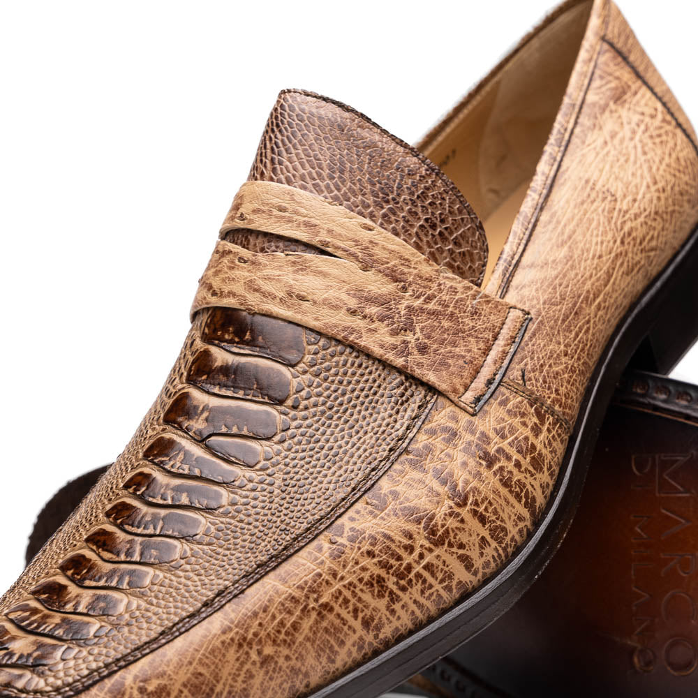 The Fangio Orix by Marco Di Milano: tan textured genuine ostrich loafers with dark brown soles, one upright and one on its side to display the sole—luxury men's shoes with hand-painted finishes.