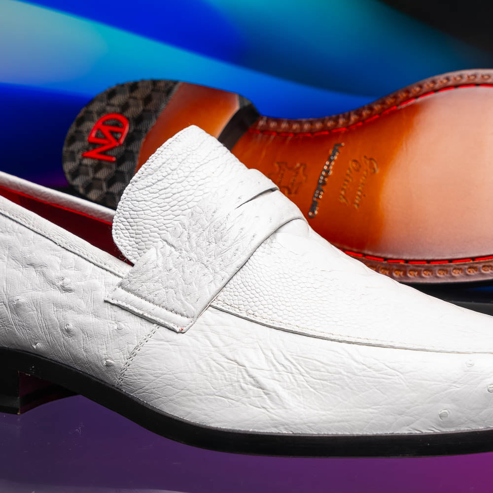 The Marco Di Milano Fangio White men's loafers feature luxurious white genuine ostrich leather with a textured finish; one stands upright, the other on its side to showcase a rich brown leather sole.