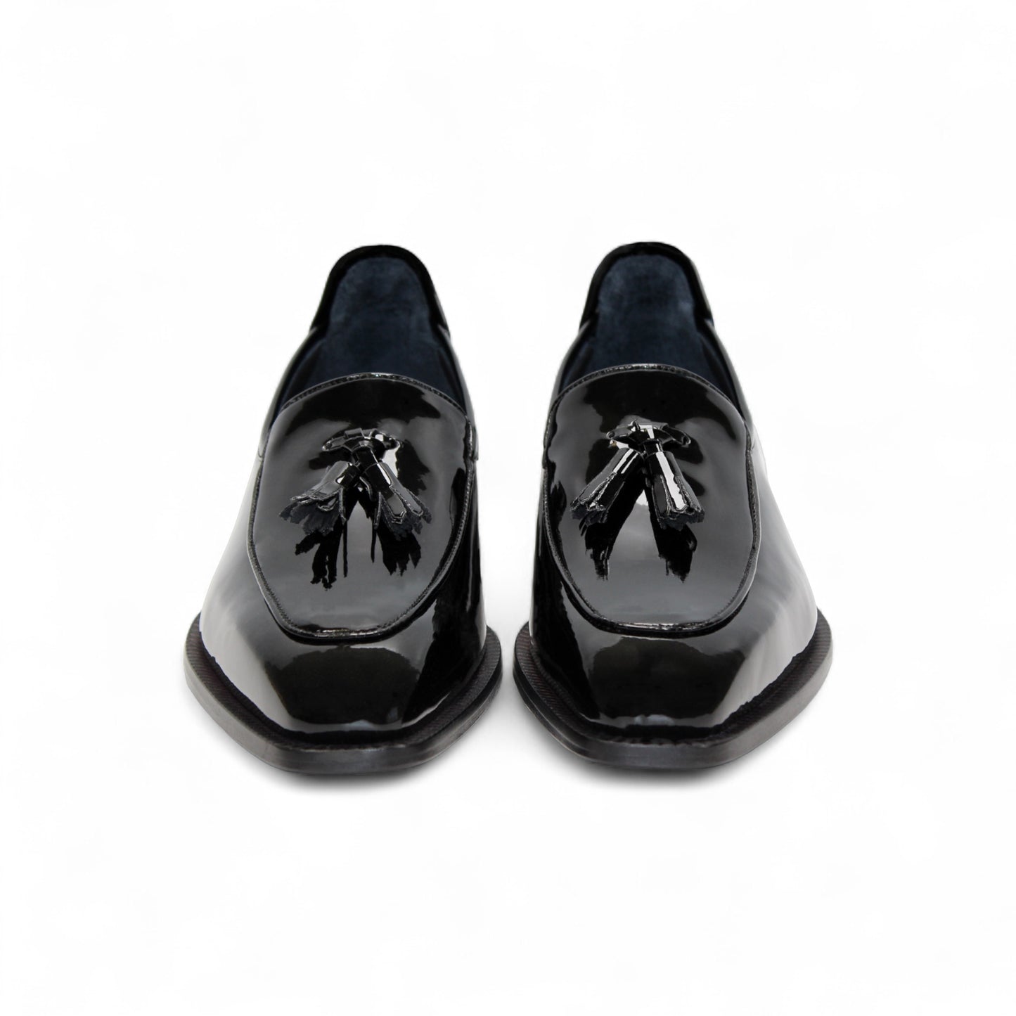 The Duca Di Matiste Duca Fano Black is a sleek black patent leather loafer with a tassel detail and low heel, made in Italy—offering minimalist luxury and timeless style on a white background.