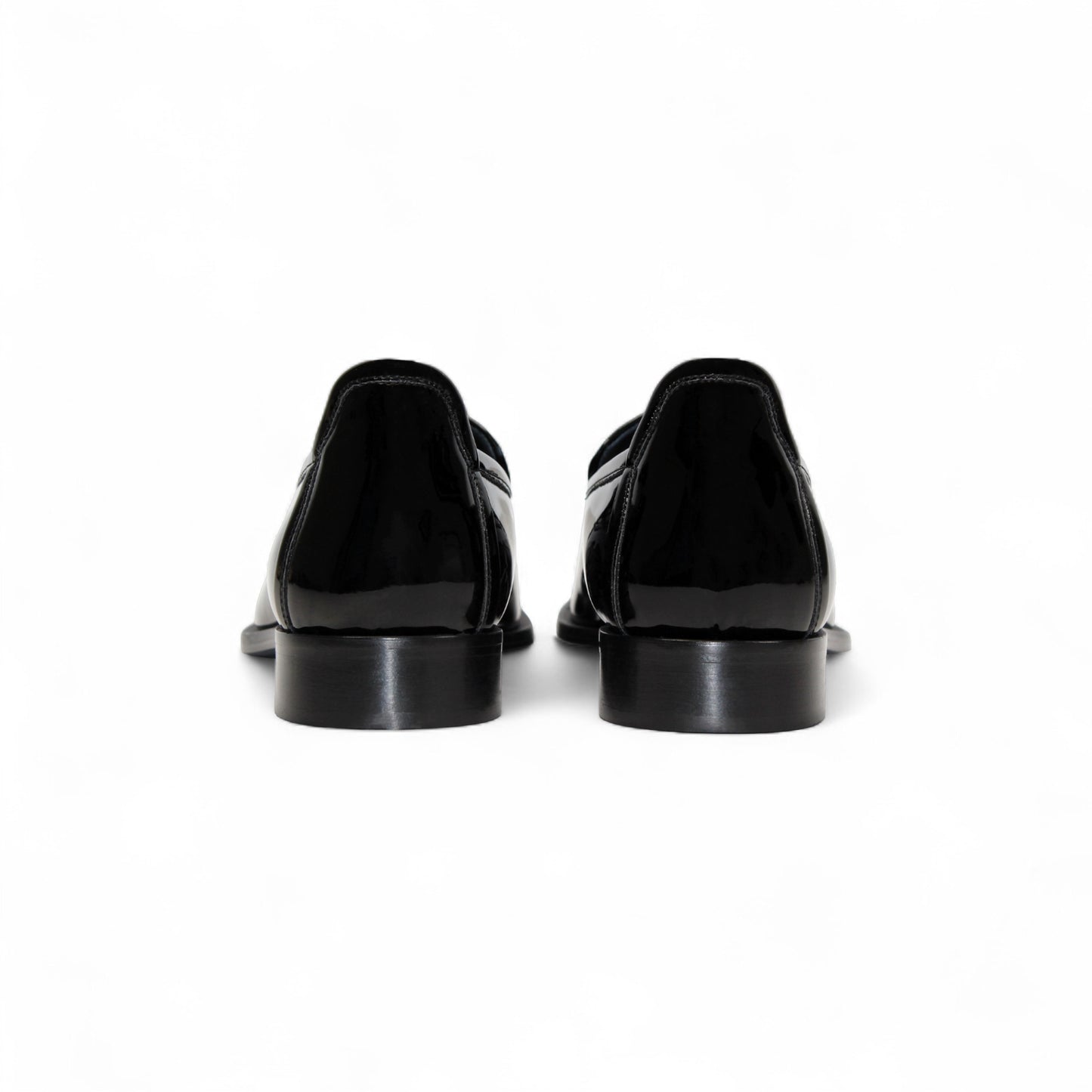 The Duca Di Matiste Duca Fano Black is a sleek black patent leather loafer with a tassel detail and low heel, made in Italy—offering minimalist luxury and timeless style on a white background.