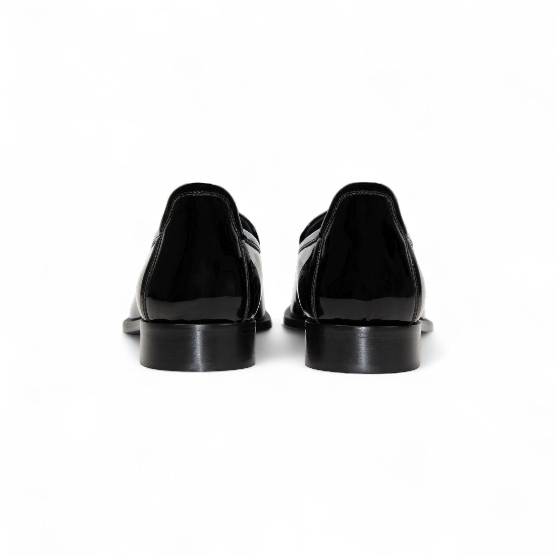 The Duca Di Matiste Duca Fano Black is a sleek black patent leather loafer with a tassel detail and low heel, made in Italy—offering minimalist luxury and timeless style on a white background.