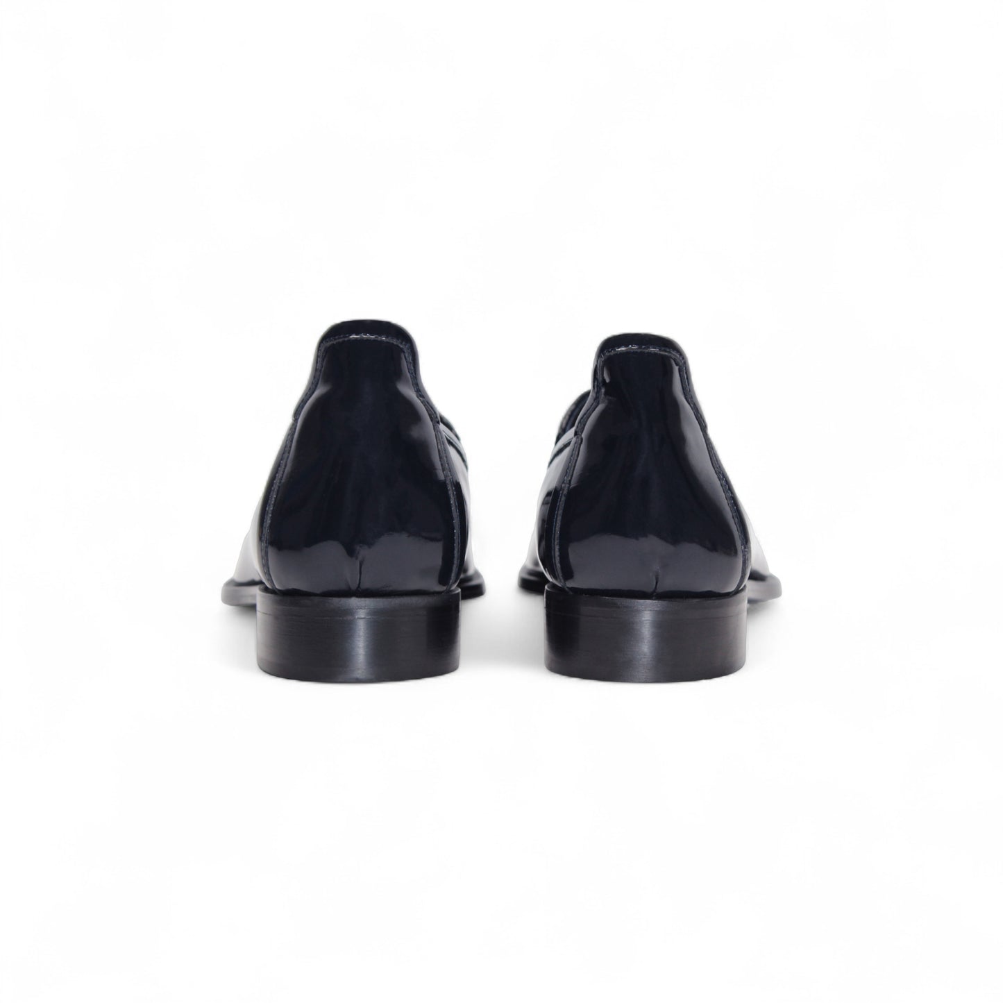 The Duca Di Matiste Duca Fano Navy loafer, featuring a tassel detail, low stacked heel, and almond toe in navy leather, showcases minimalist elegance in a side profile against a white background.