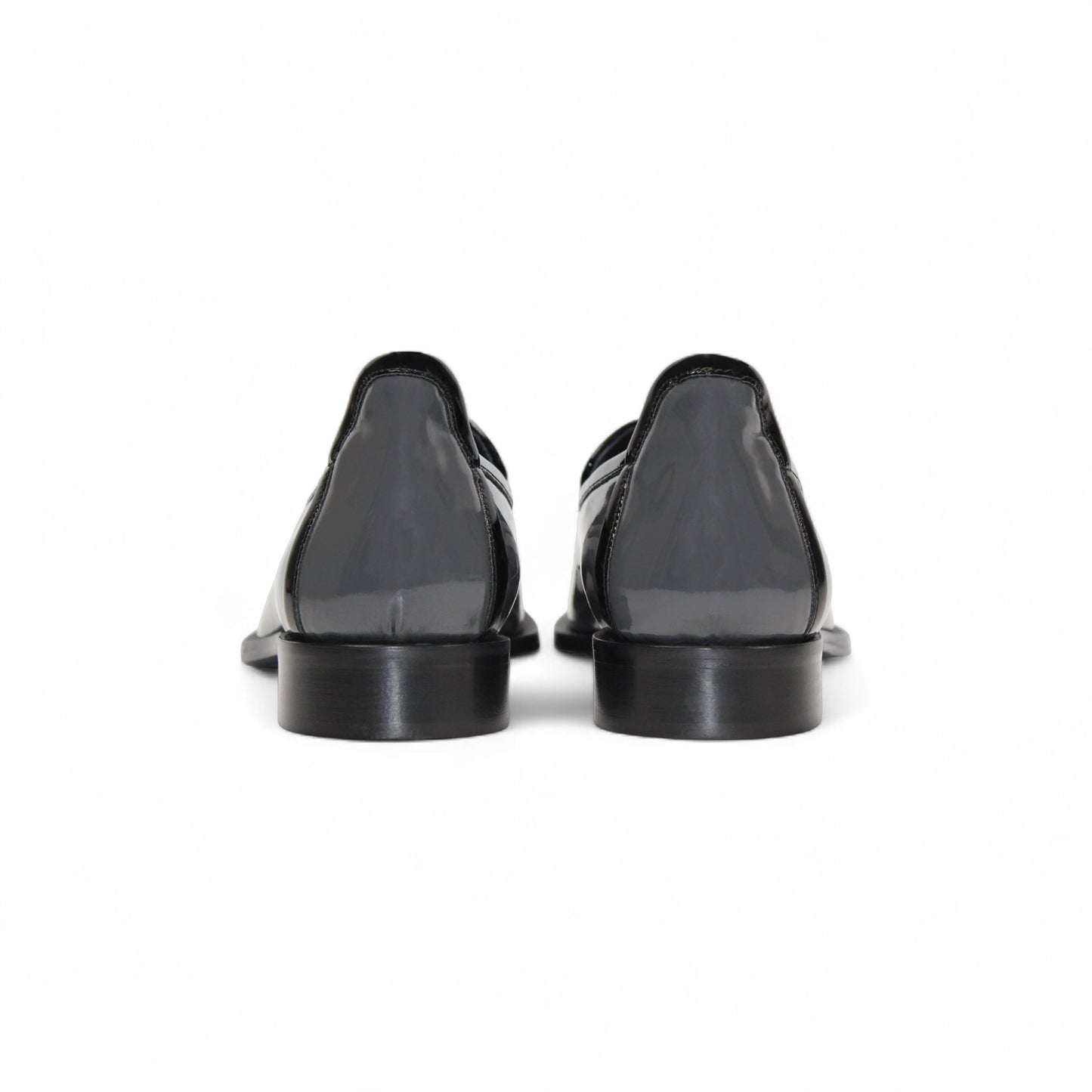 The Duca Di Matiste Duca Fano Grey/Black is an Italian-crafted glossy patent leather loafer with front tassel detail, low black heel, and black sole—showcasing minimalist luxury from every angle.