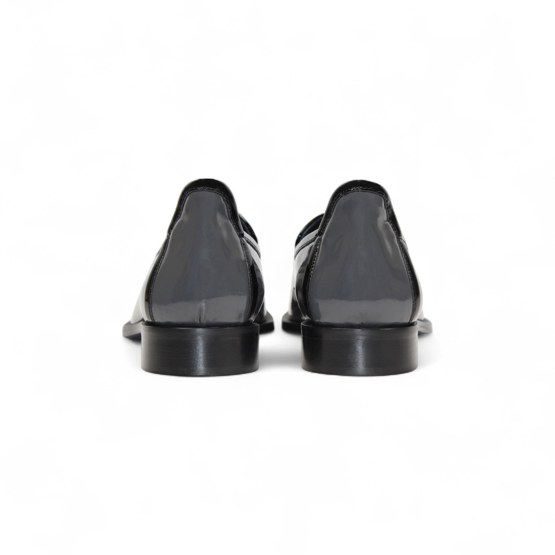 The Duca Di Matiste Duca Fano Grey/Black is an Italian-crafted glossy patent leather loafer with front tassel detail, low black heel, and black sole—showcasing minimalist luxury from every angle.