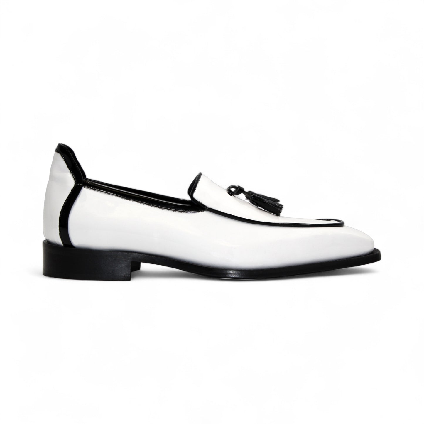The Duca Di Matiste Duca Fano White/Black loafer features white patent leather, black trim, tassel detail, a low heel, and a glossy finish—shown minimalist style on a plain white background.