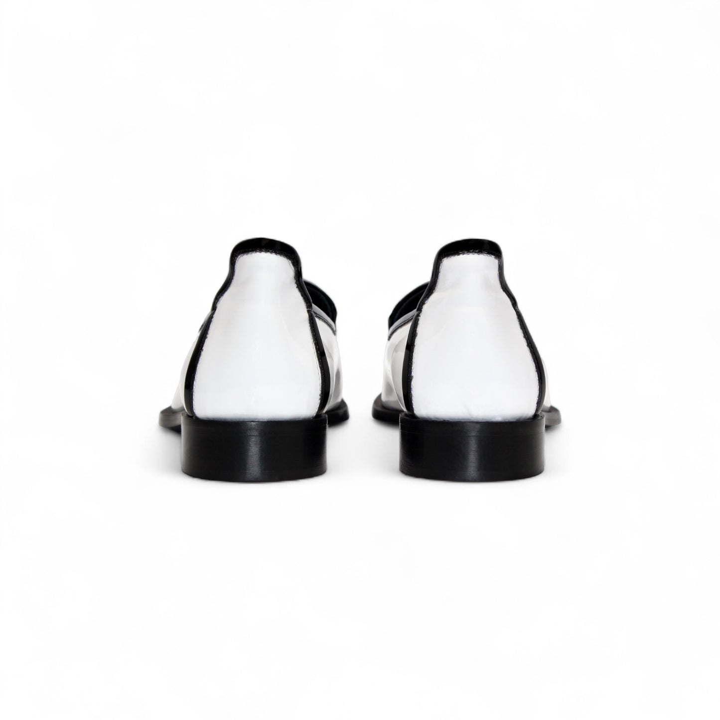 The Duca Di Matiste Duca Fano White/Black loafer features white patent leather, black trim, tassel detail, a low heel, and a glossy finish—shown minimalist style on a plain white background.