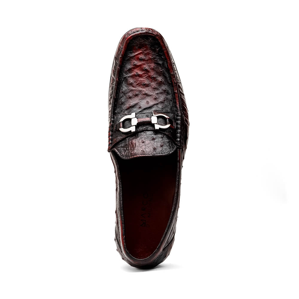 The Marco Di Milano Ferrioni BlackCherry loafers, shown with one upright and one on its side to reveal the sole, feature classic metal bit detailing—ideal for those seeking luxury men's footwear.