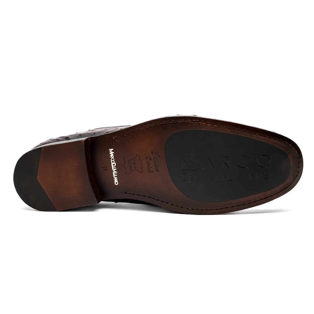 The Marco Di Milano Ferrioni BlackCherry loafers, shown with one upright and one on its side to reveal the sole, feature classic metal bit detailing—ideal for those seeking luxury men's footwear.