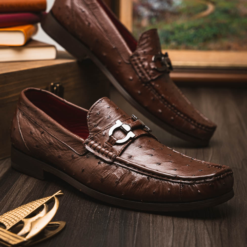 Experience luxury with the Ferrioni Kango Tabac by Marco Di Milano—brown leather men's loafers featuring a textured finish, metal buckle detail, and signature branding on the sole.