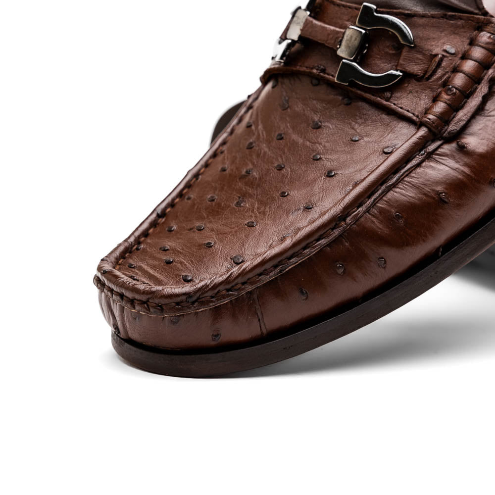 Experience luxury with the Ferrioni Kango Tabac by Marco Di Milano—brown leather men's loafers featuring a textured finish, metal buckle detail, and signature branding on the sole.