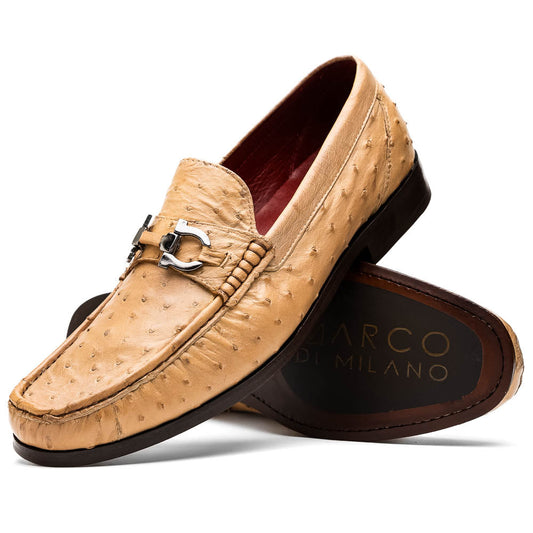 The Marco Di Milano Ferrioni Orix is a pair of genuine beige ostrich loafers with a classic bit buckle, one upright and one on its side showing the insole logo—timeless luxury men's footwear.