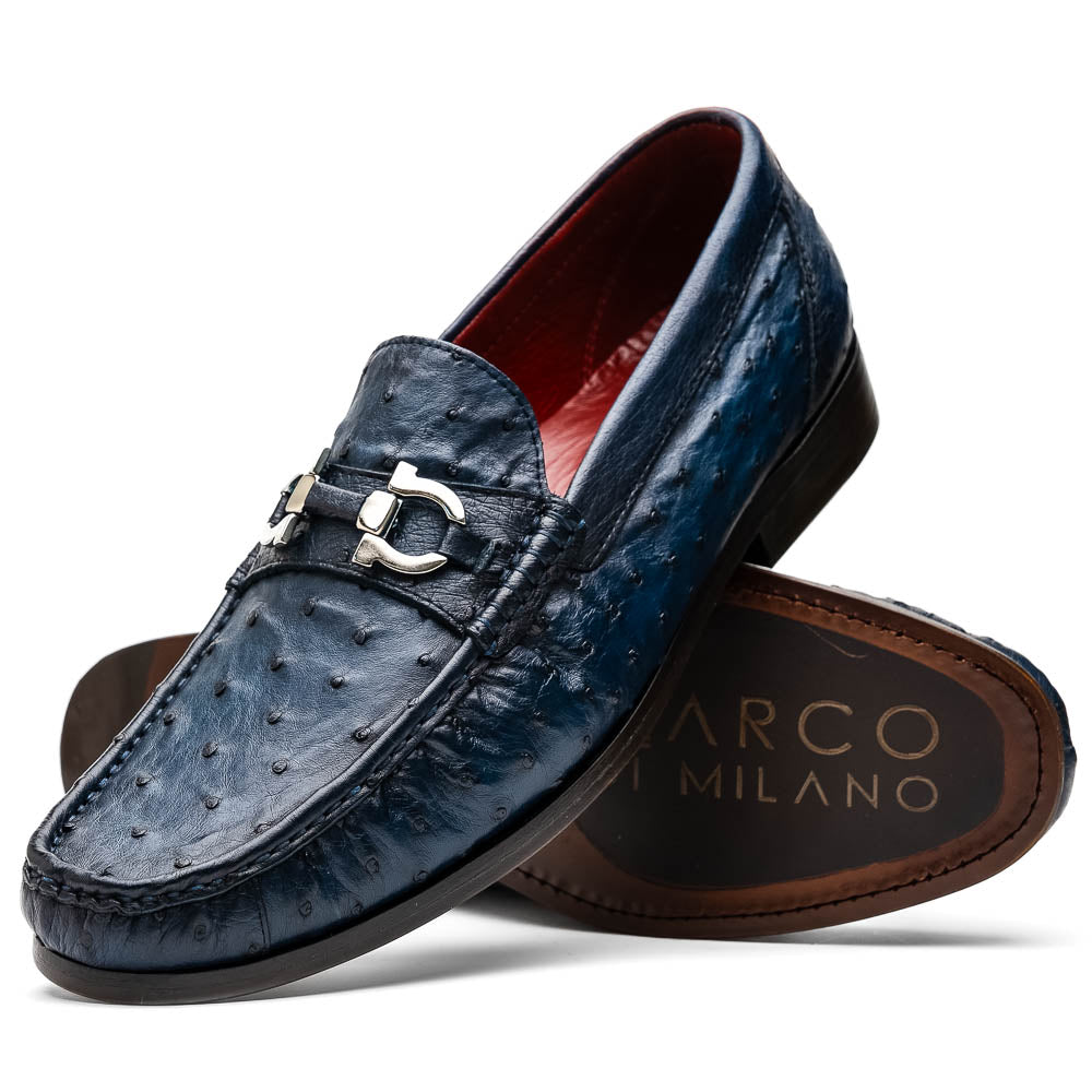 A pair of luxury men's shoes: Ferrioni Navy loafers by Marco Di Milano in genuine ostrich leather, featuring classic bit detail. One shoe is upright, the other shows the sole with "Marco Di Milano" branding.